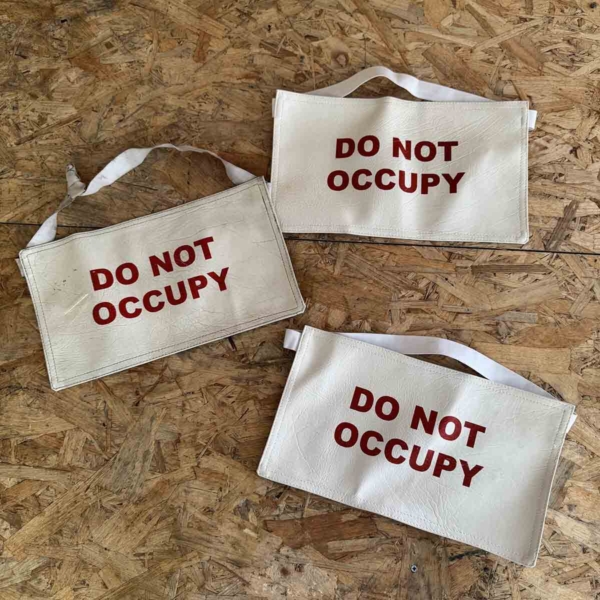 Seat covers 'do not occupy' for sale.