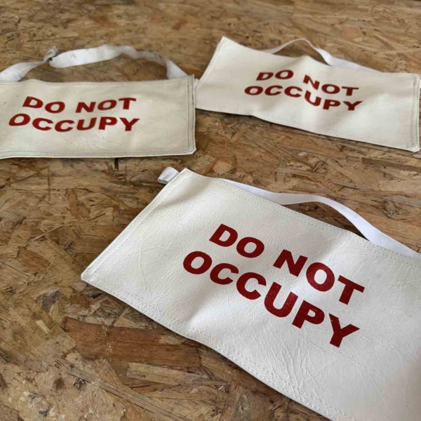 Seat covers 'do not occupy' for sale.